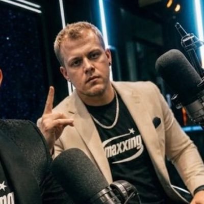 Portrait of K1d Crypt0 hosting a crypto podcast on the mic